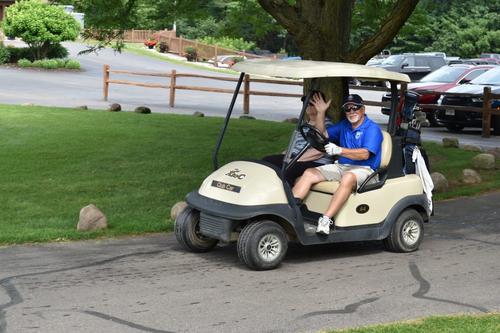 Golfer driving a golf cart